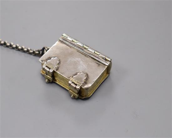 A German gilded white metal chatelaine box in the form of an early book, H 3.5cm W 2.5cm
